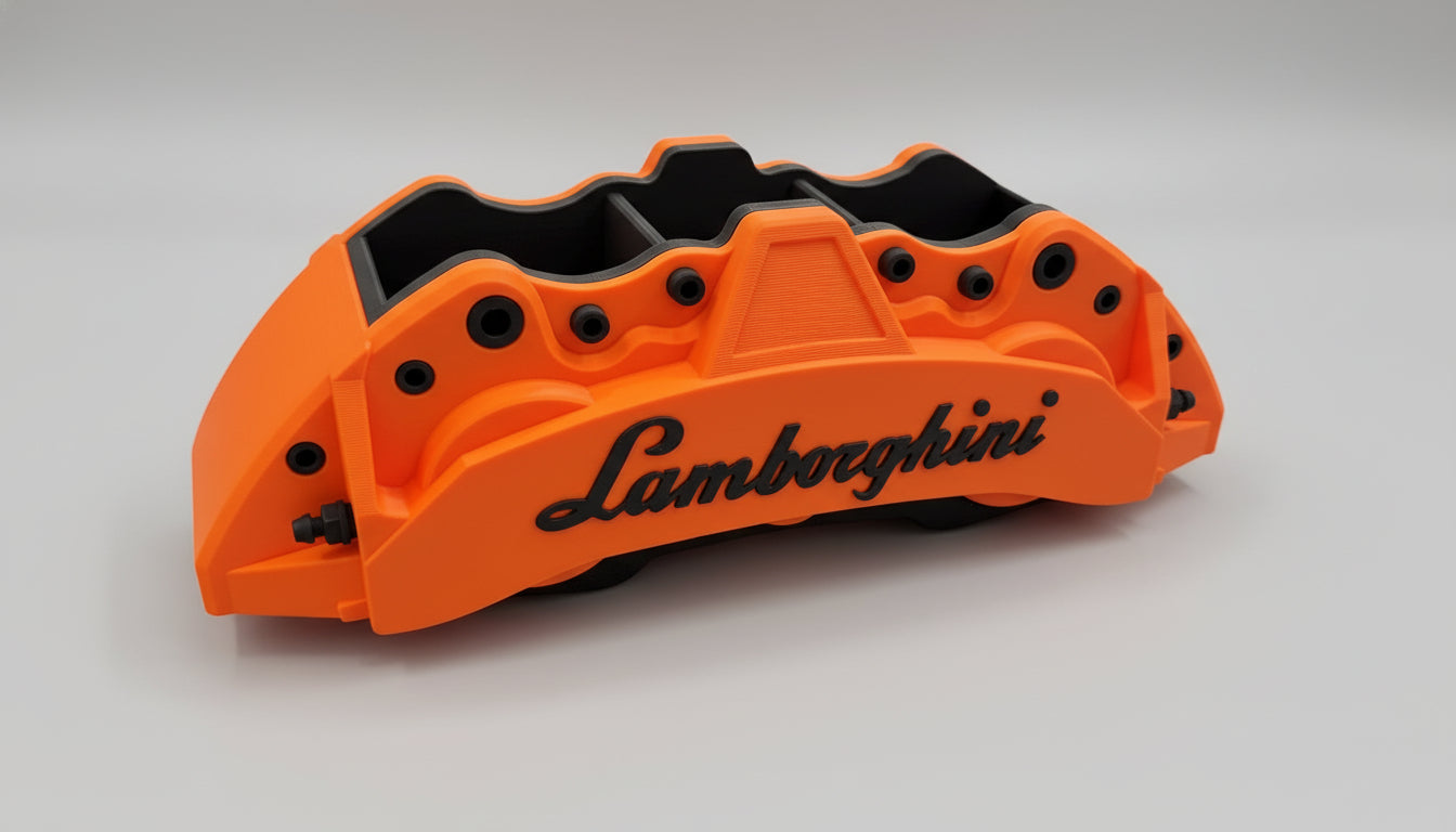 Orange car brake caliper with Lamborghini logo on a reflective surface