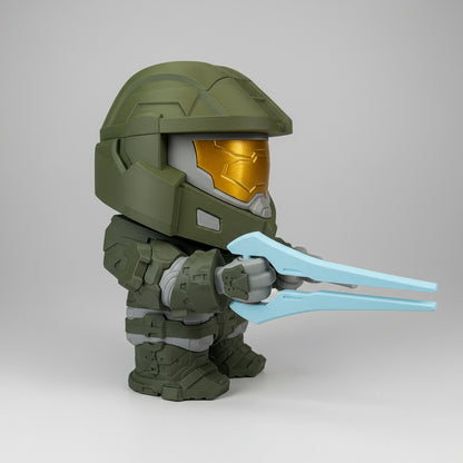 Toy figure of a character with a helmet and blue visor on a white surface.